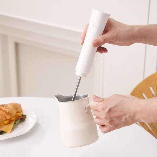 Portable milk frother with rechargeable USB, stainless steel whisk, compact white design for café-quality foam on the go