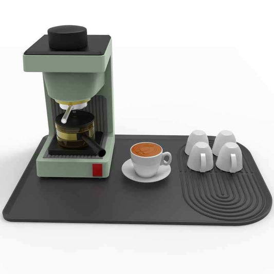 Large black silicone coffee machine mat protecting countertop from drips and scratches